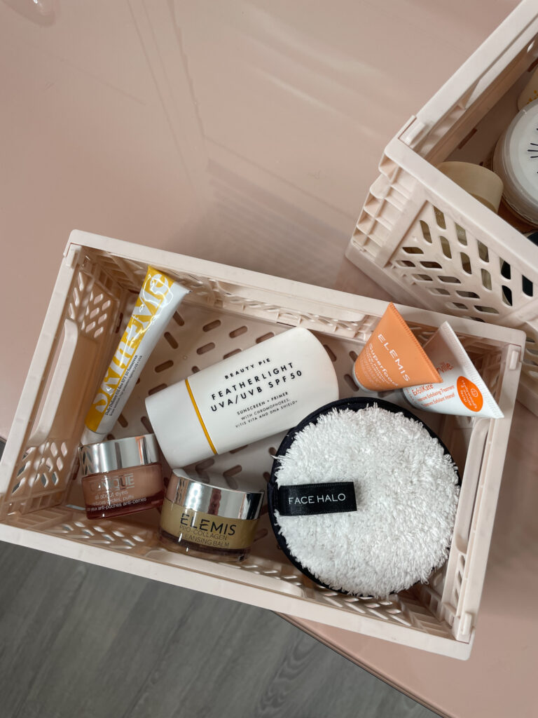 skincare routine in a pale pink storage box